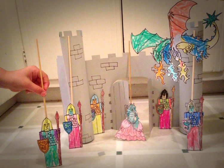 I made the castle out of card stock and tape and the puppets are card stock, tape, BBQ skewers. 