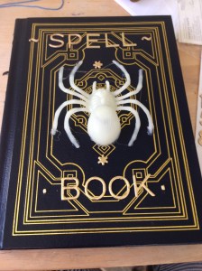 Hot glue some plastic creature on. Add some letters. 